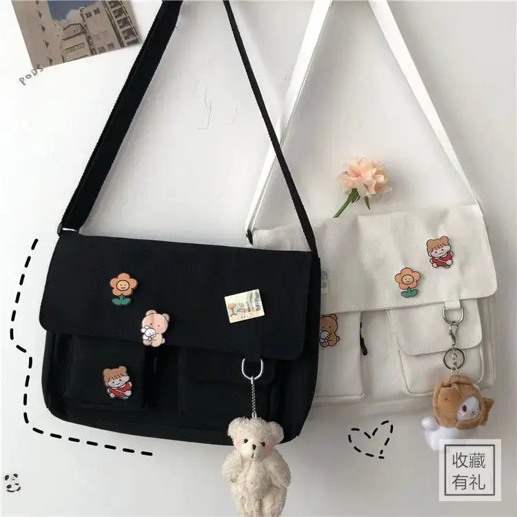 Simples Market women's canvas messenger bags; two color options black and white, with cartoon patches and teddy keychain.