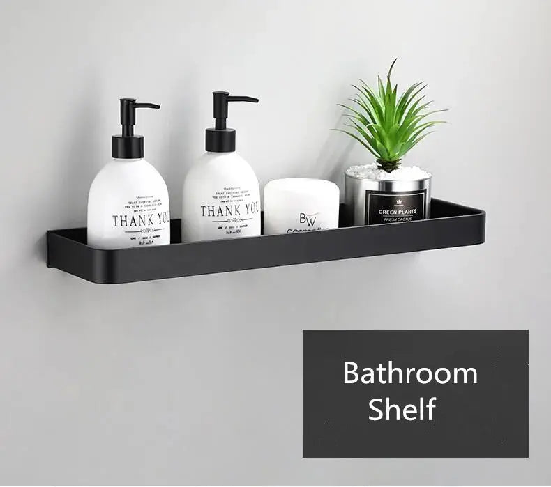 Wall-mounted bathroom shelf in black aluminum holding two pump bottles, a white jar, and a small plant.