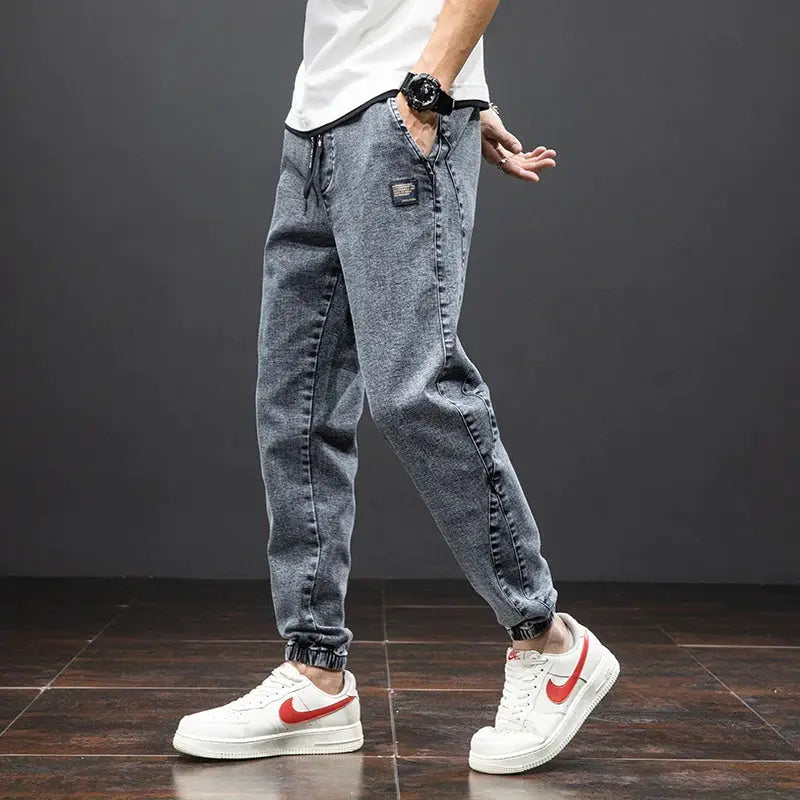 Men's blue cargo denim jogger pants with baggy fit and cargo pockets