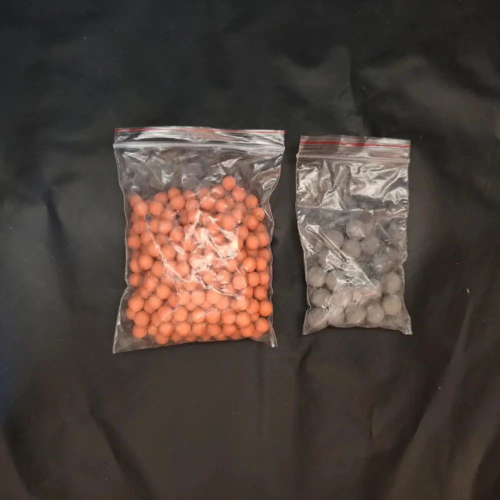 Shower head filter beads in two bags: orange energy anion mineral beads and gray ceramic purification stones