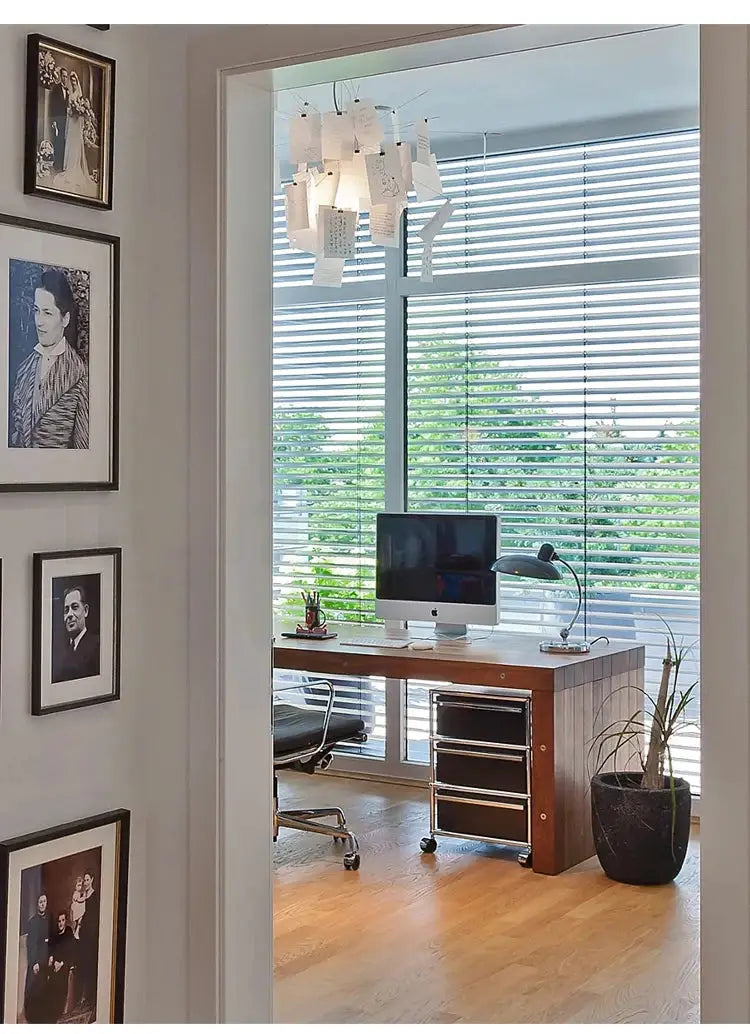 Paper chandelier replica by Ingo Maurer with LED E27, hanging over a modern home office desk.