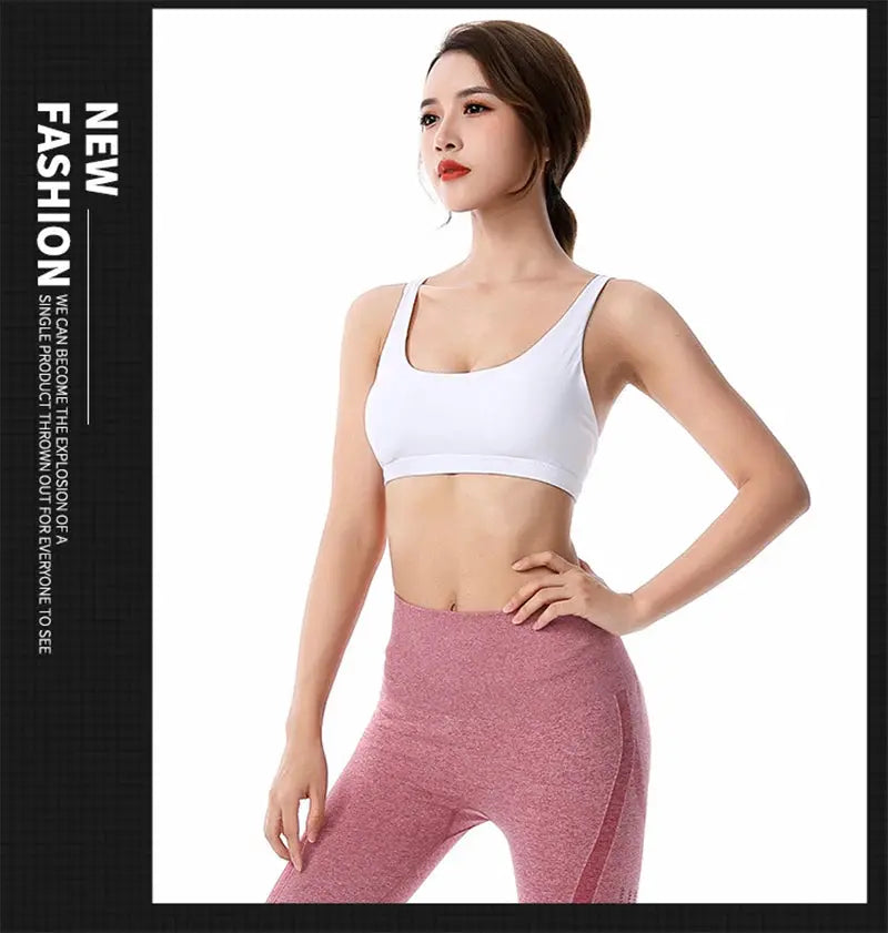 Women's white fitness sports bra with cross-back design, paired with pink leggings.
