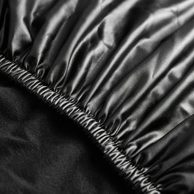 Corner sofa slipcover in black waterproof PU fabric with elastic edge.