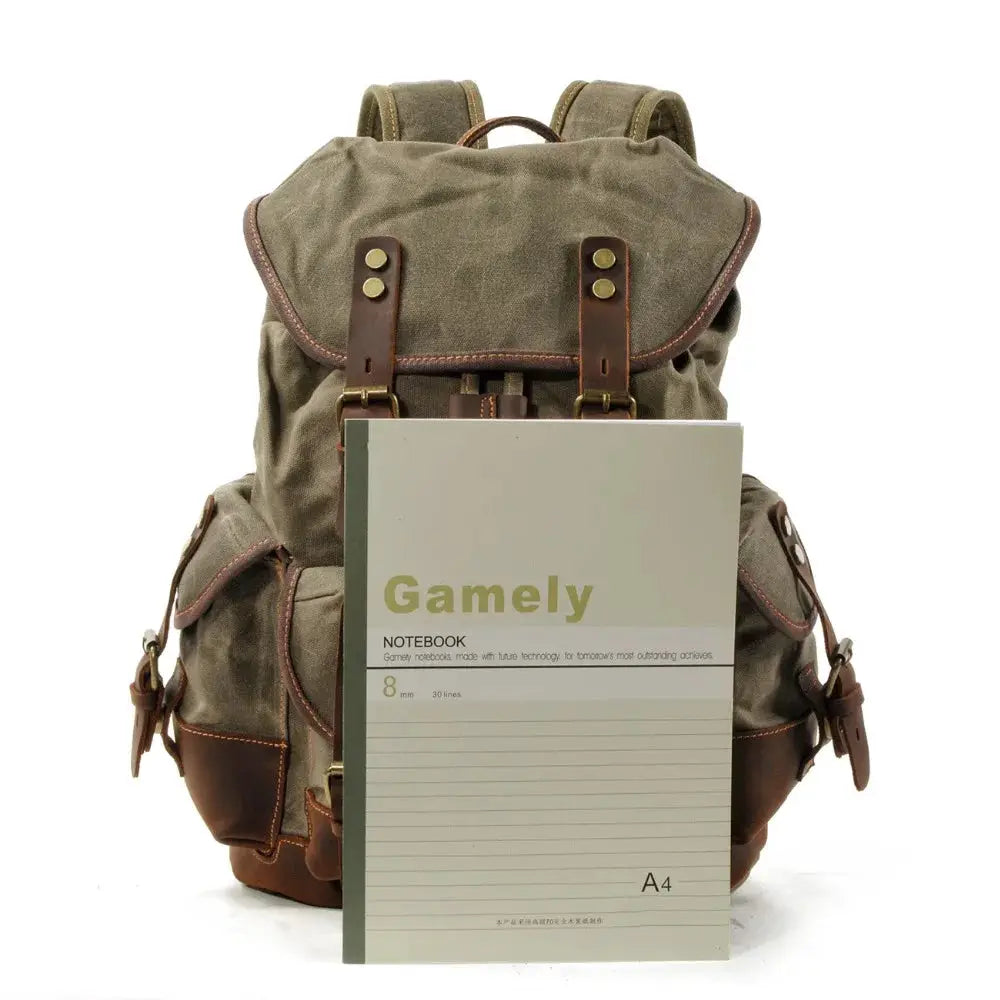 Vintage canvas backpack with leather straps and waxed trim in tan-brown