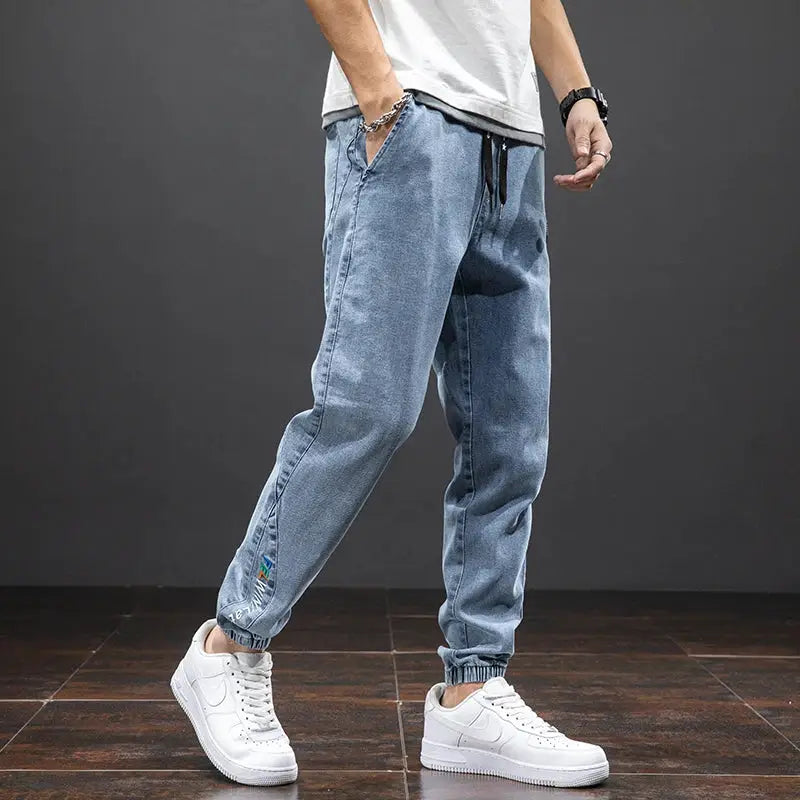 Men's light blue denim cargo jogger pants with drawstring waist and elastic cuffs
