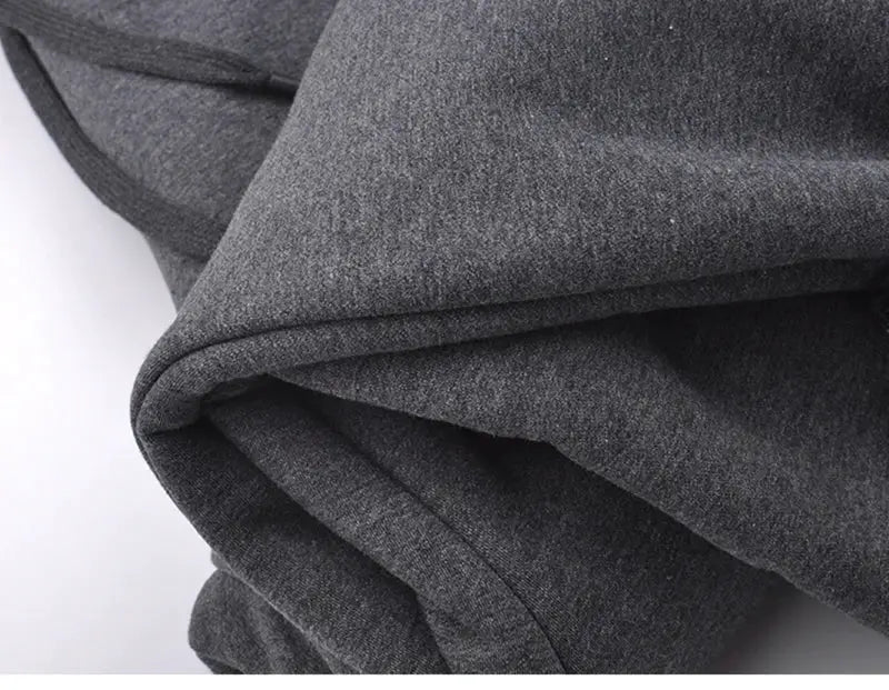 Men's winter fleece sweatpants fabric close-up in grey knit material