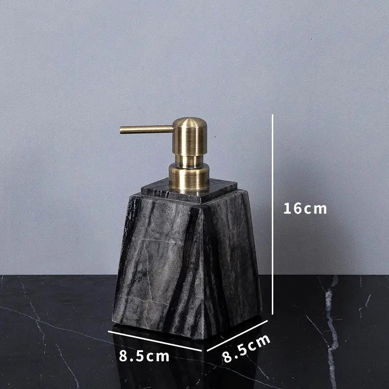 Soap dispenser with brass pump on an ancient wood-grain marble base for the bathroom.