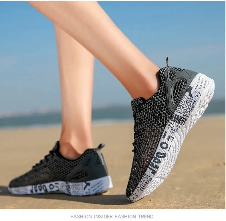 Mens water shoes in black mesh with foam sole featuring newspaper-print design, ideal for beach wear.
