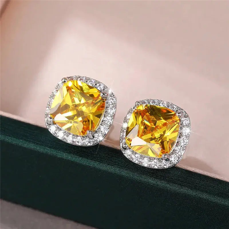 Huitan cushion-shape stud earrings, a pair with yellow cubic zirconia stones and a silver-tone halo; Simples Market