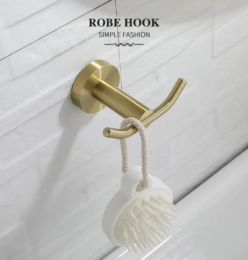 Brushed gold robe hook wall mount with circular base, holding a white bath brush on rope