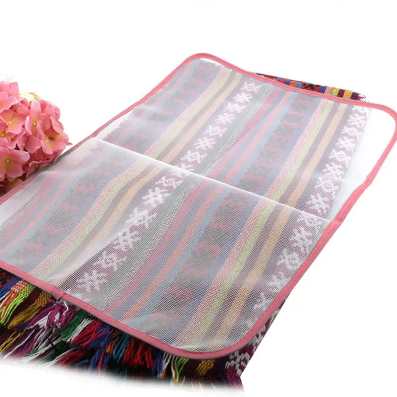 Clothes ironing protection pad, mesh ironing board cover with pink trim on a colorful woven board cover.