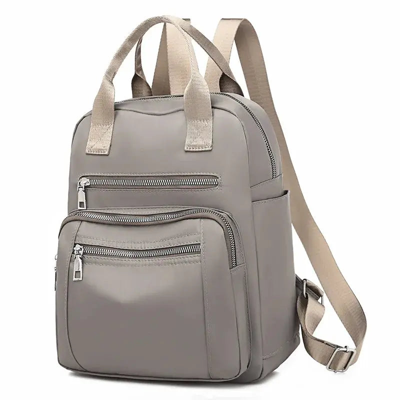 Simples Market women's backpack, grey waterproof Oxford fabric with beige straps, multiple zip pockets.