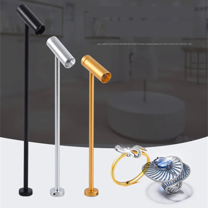 LED spotlight post lamp set by Simples Market; three upright rotatable lamps in black, silver and gold.