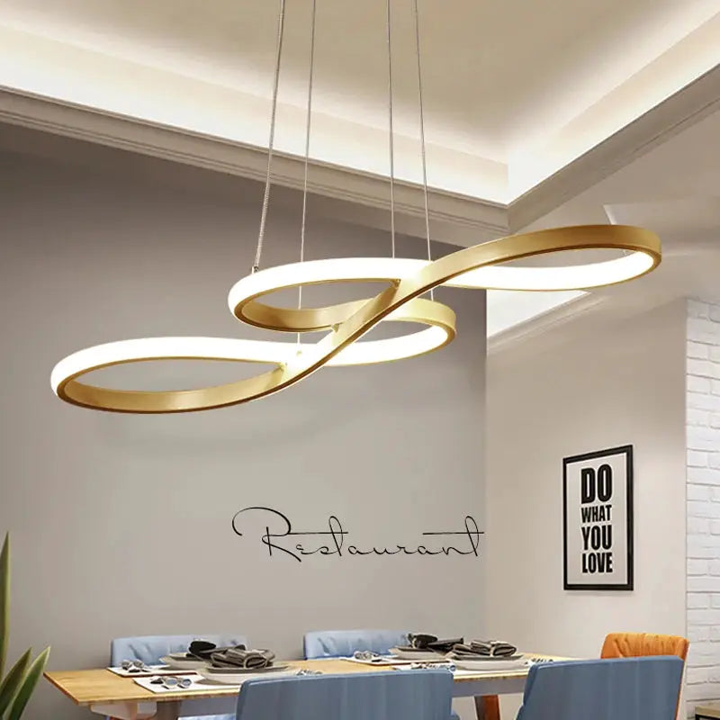Pendant light, gold metal LED rings hanging over a dining table
