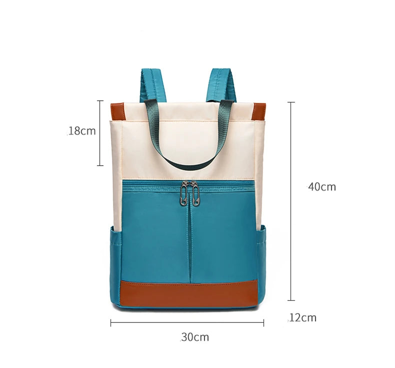 Women's waterproof Oxford backpack in teal with beige top and brown base; front zip pocket.