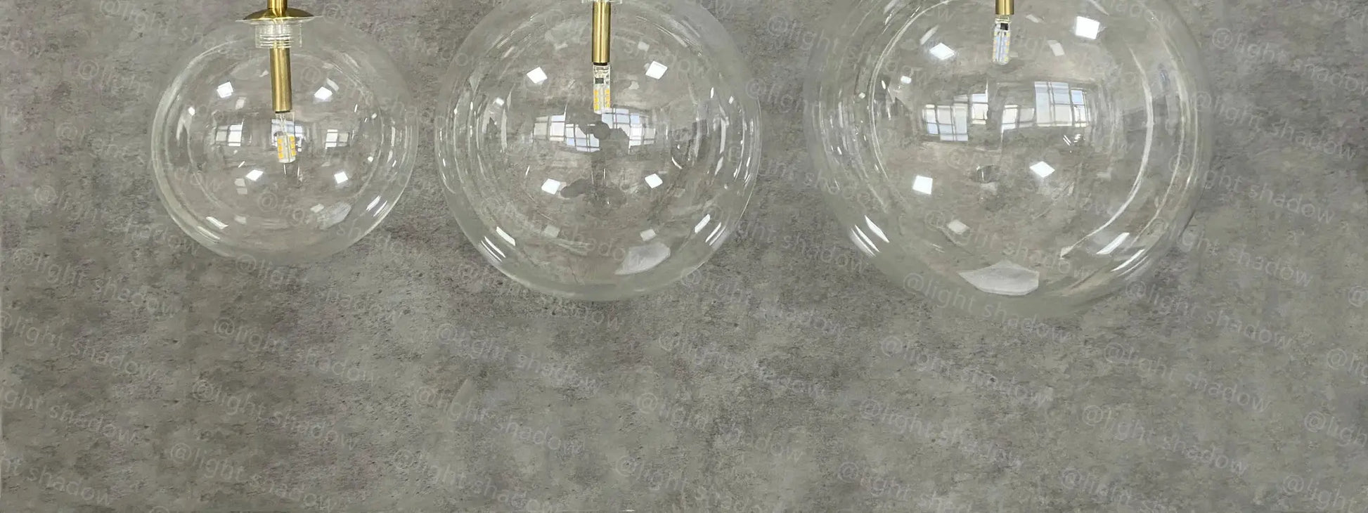 Modern LED pendant lamp with clear glass globe shades and brass gold suspensions, set of 3