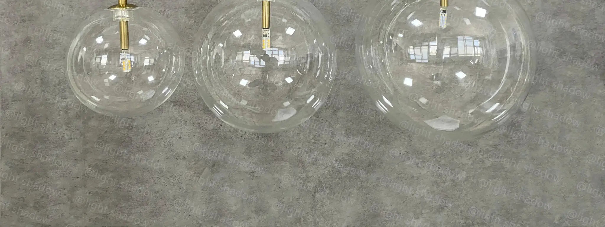 Modern LED pendant lamp with clear glass globe shades and brass gold suspensions, set of 3
