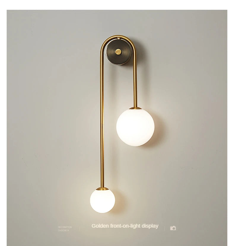 Modern wall lamp by Simples Market with twin glass globe shades and gold finish