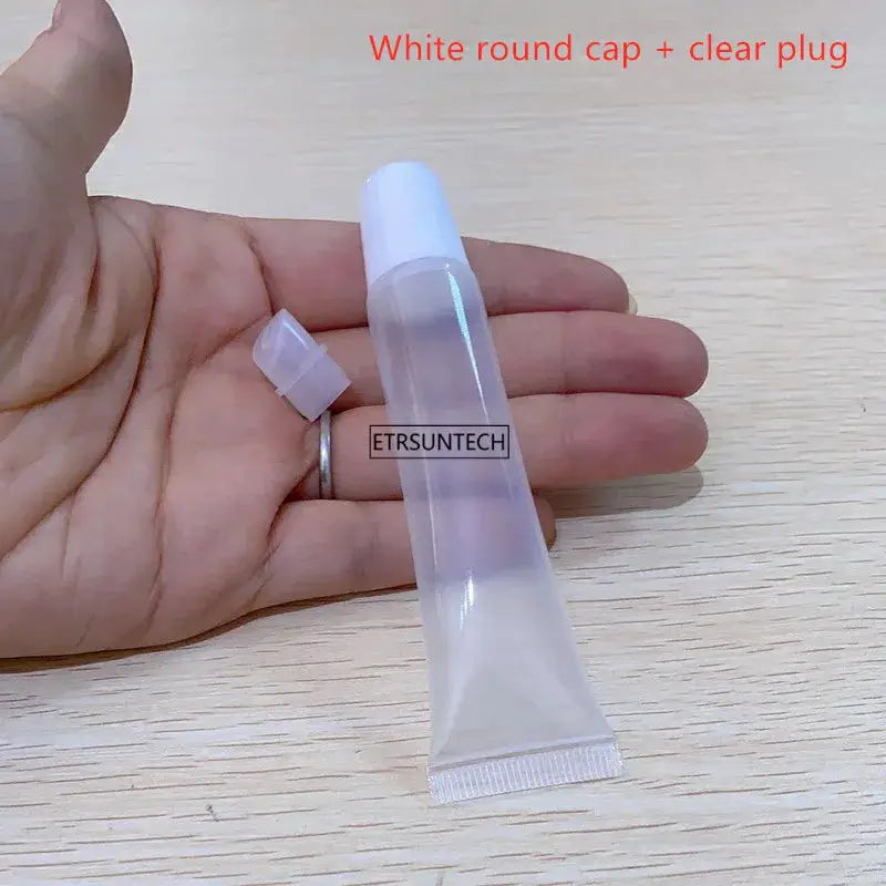 Clear empty lipstick tube with white round cap and plug, squeeze bottle for lip balm