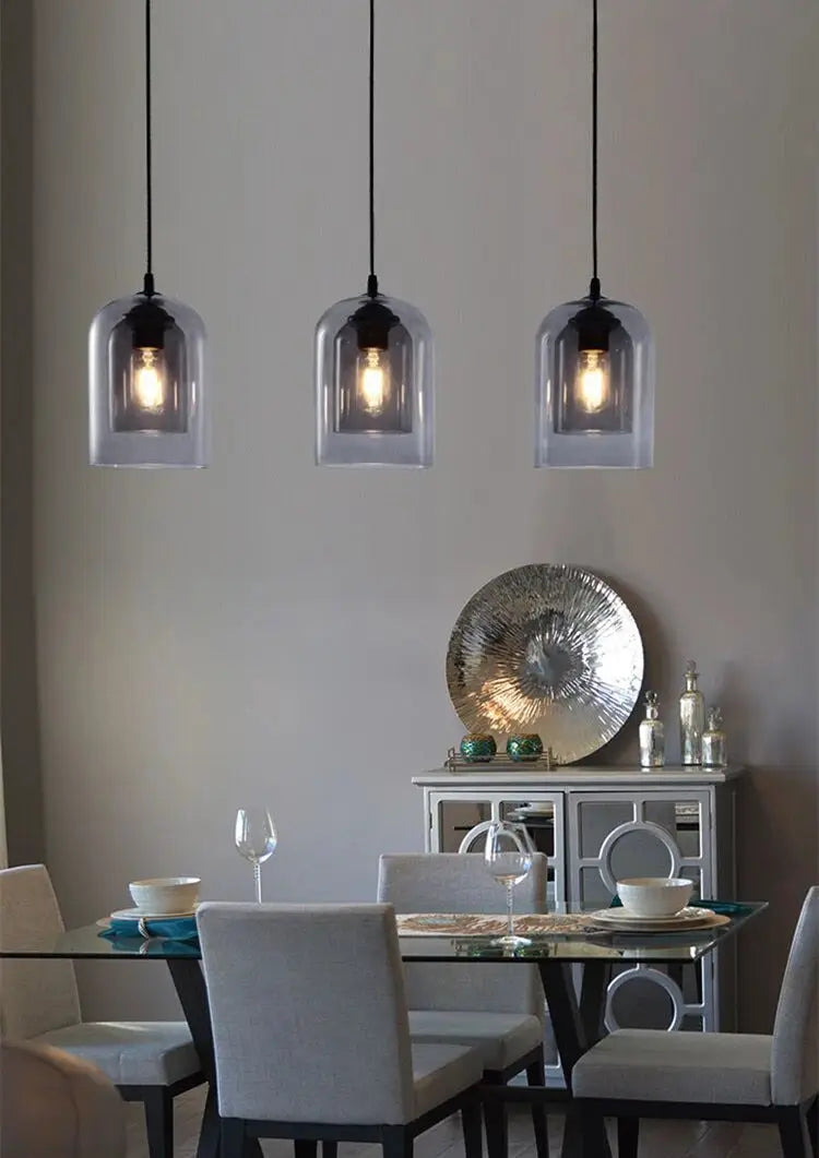 Three Nordic gray glass pendant lamps with clear glass domes over a dining table, E27 suspension lights