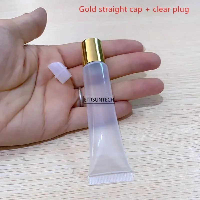 Clear lipstick tube with gold cap, empty 10–20ml bottle, hand-held display
