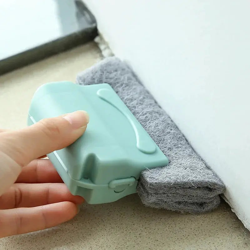 Groove cleaning brush; mint-green plastic window cleaning tool with a gray microfiber pad.