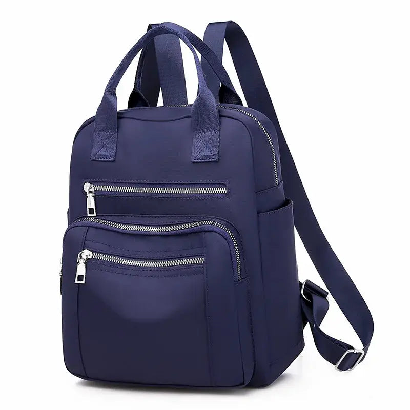 Women's navy waterproof Oxford backpack Simples Market with multiple zip pockets and adjustable straps.