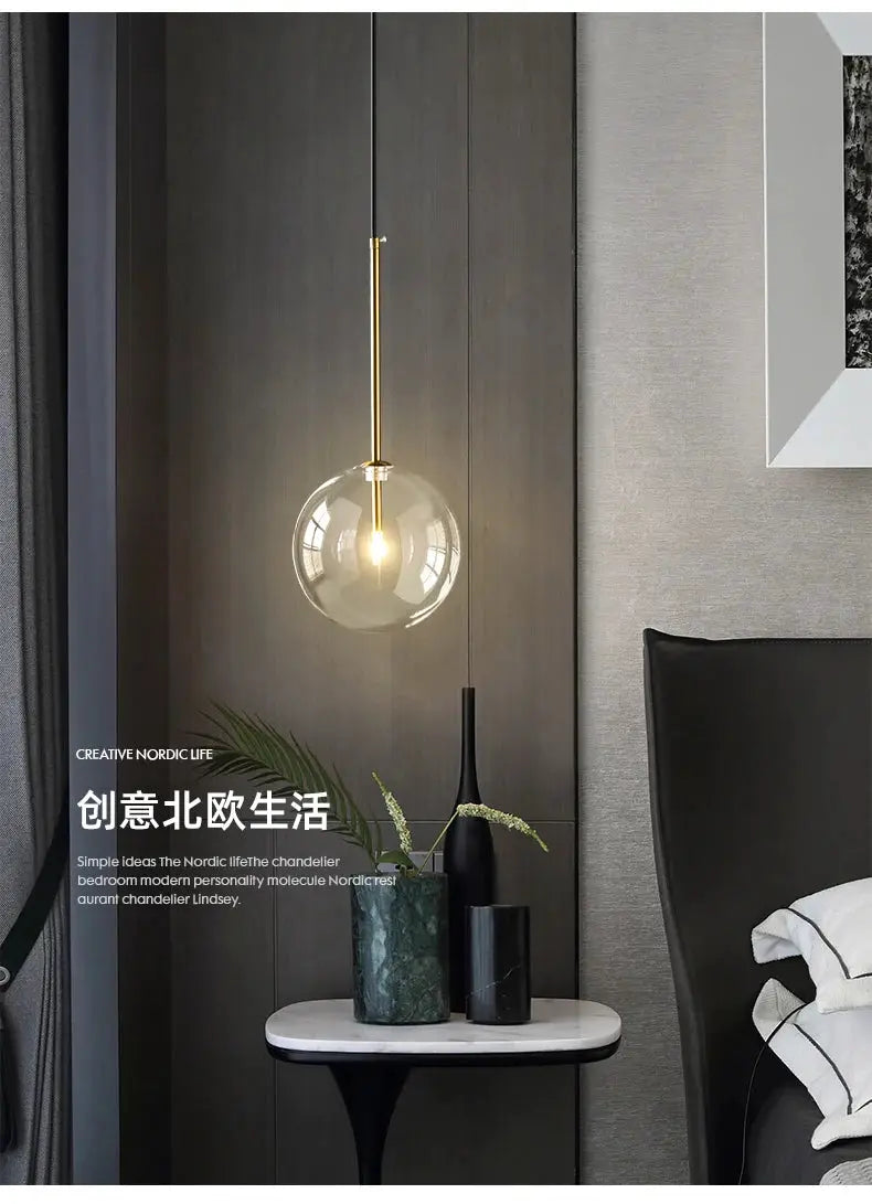 Modern LED pendant lamp with a glass ball globe and gold suspension rod for bedroom decor