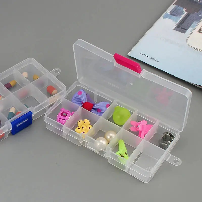 Clear 10-slot plastic storage box for jewelry and craft beads, open lid with pink latch, showing colorful contents.