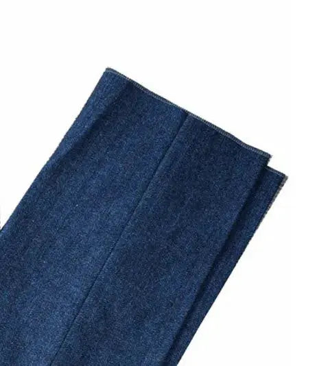 Blue denim fabric swatch with seam detail, folded close-up.