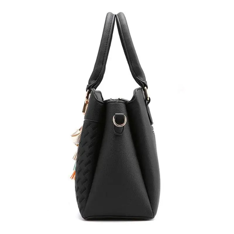 Simples Market black PU leather tote with top-handle, tassel accents and gold hardware