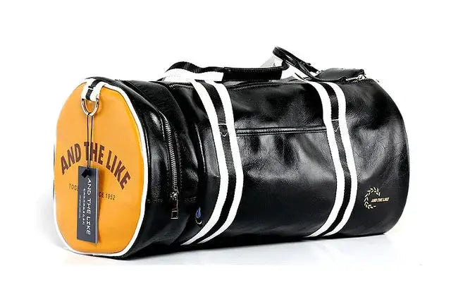 Sport gym bag in black faux leather with an orange circular end, white striped accents and a shoe storage pocket