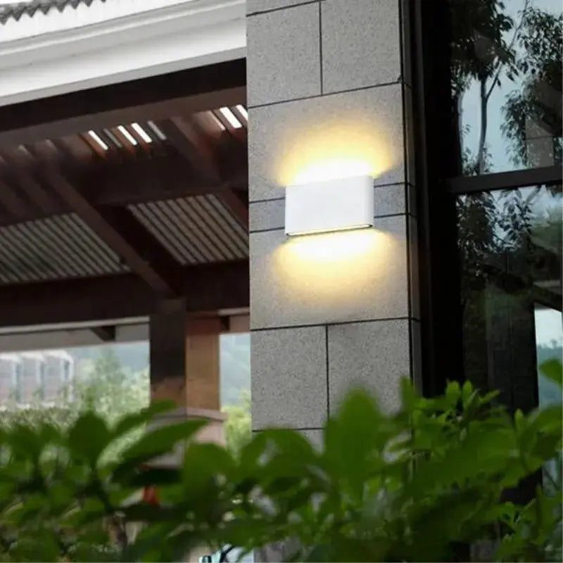 LED wall light by Simples Market, outdoor waterproof white aluminum fixture with warm up-down glow.