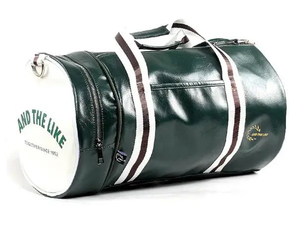 Sport gym bag in green leather with white striped handles and built-in shoe storage pocket.