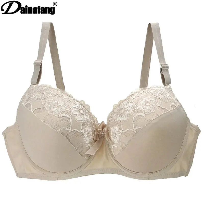 Beige lace bra with underwire, satin bow centerpiece and adjustable straps; Dainafang logo visible