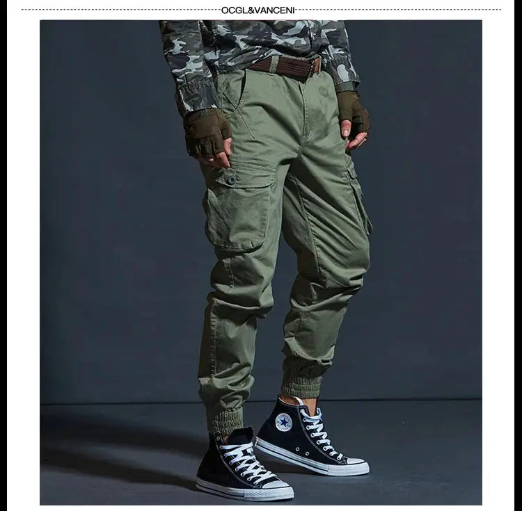 Khaki cargo jogger pants for men with multiple pockets; olive-green tactical workwear, Converse sneakers visible.