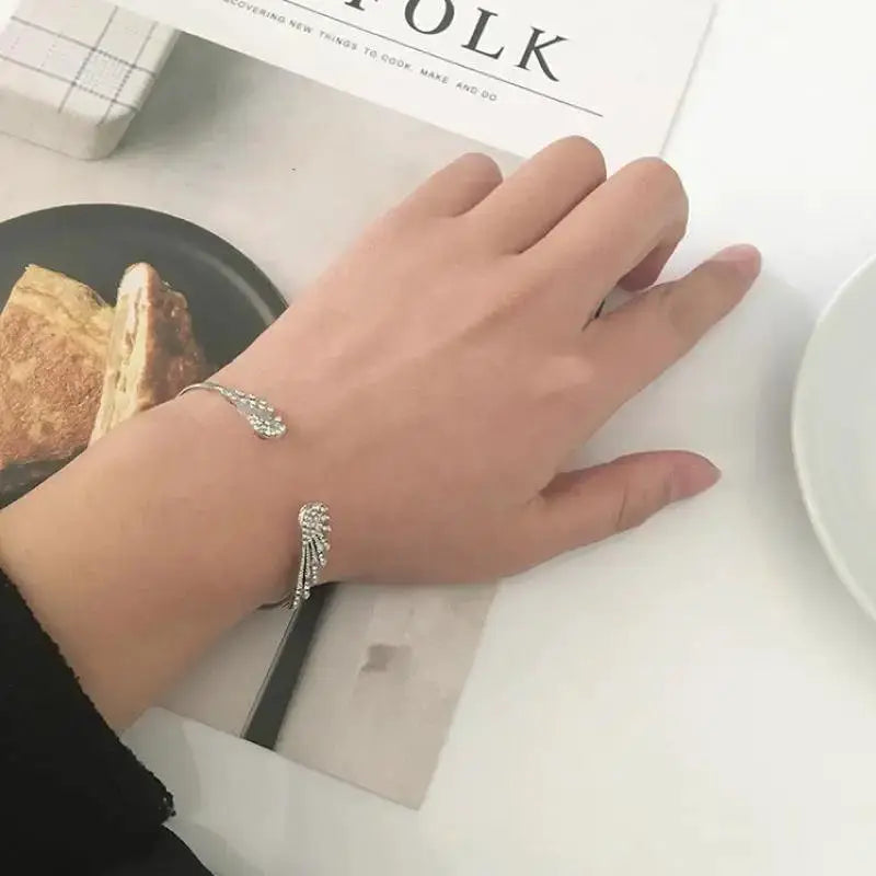 Adjustable silver angel wings bracelet for women, open cuff with crystal accents