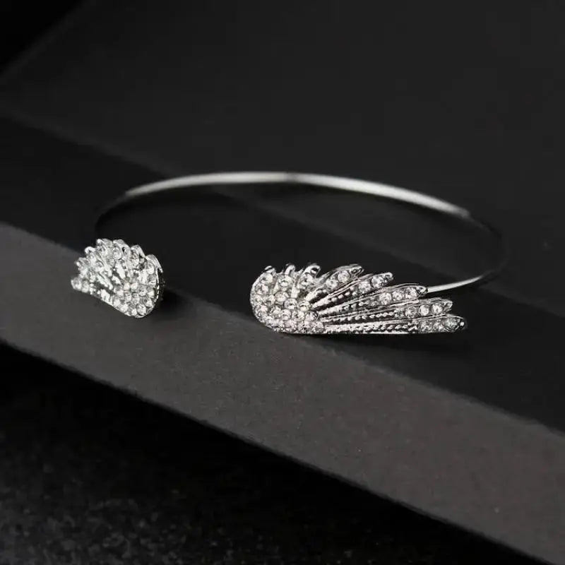 Adjustable silver angel wings bracelet for women with crystal accents, open cuff, Simples Market.