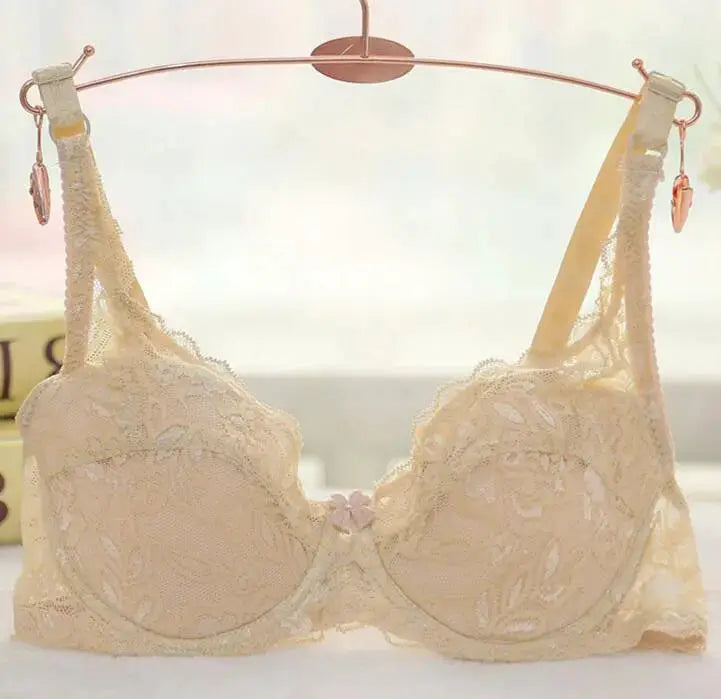 Women's beige lace underwire push-up bra on a hanger, floral lace pattern, adjustable straps