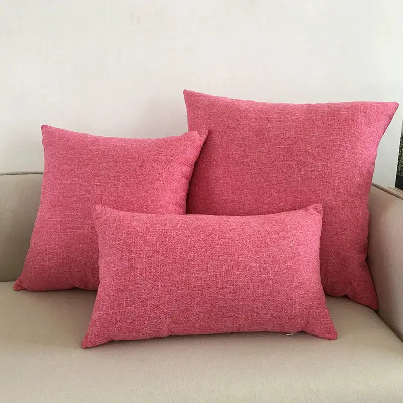 Sofa cushions set of 3 in pink textured fabric on a beige sofa