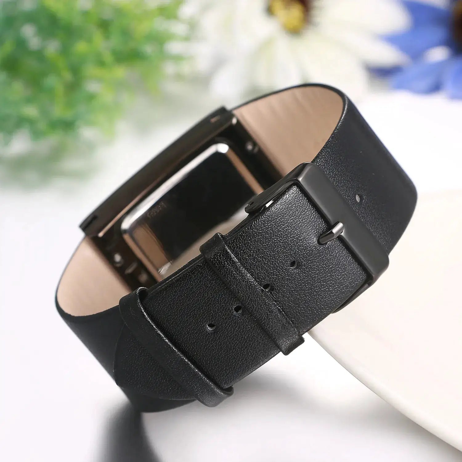 Watch with black genuine leather strap and rectangular case with a metal buckle