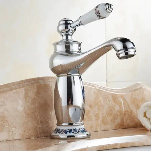 Bathroom faucet with ornate vintage design and chrome finish for basin sink.