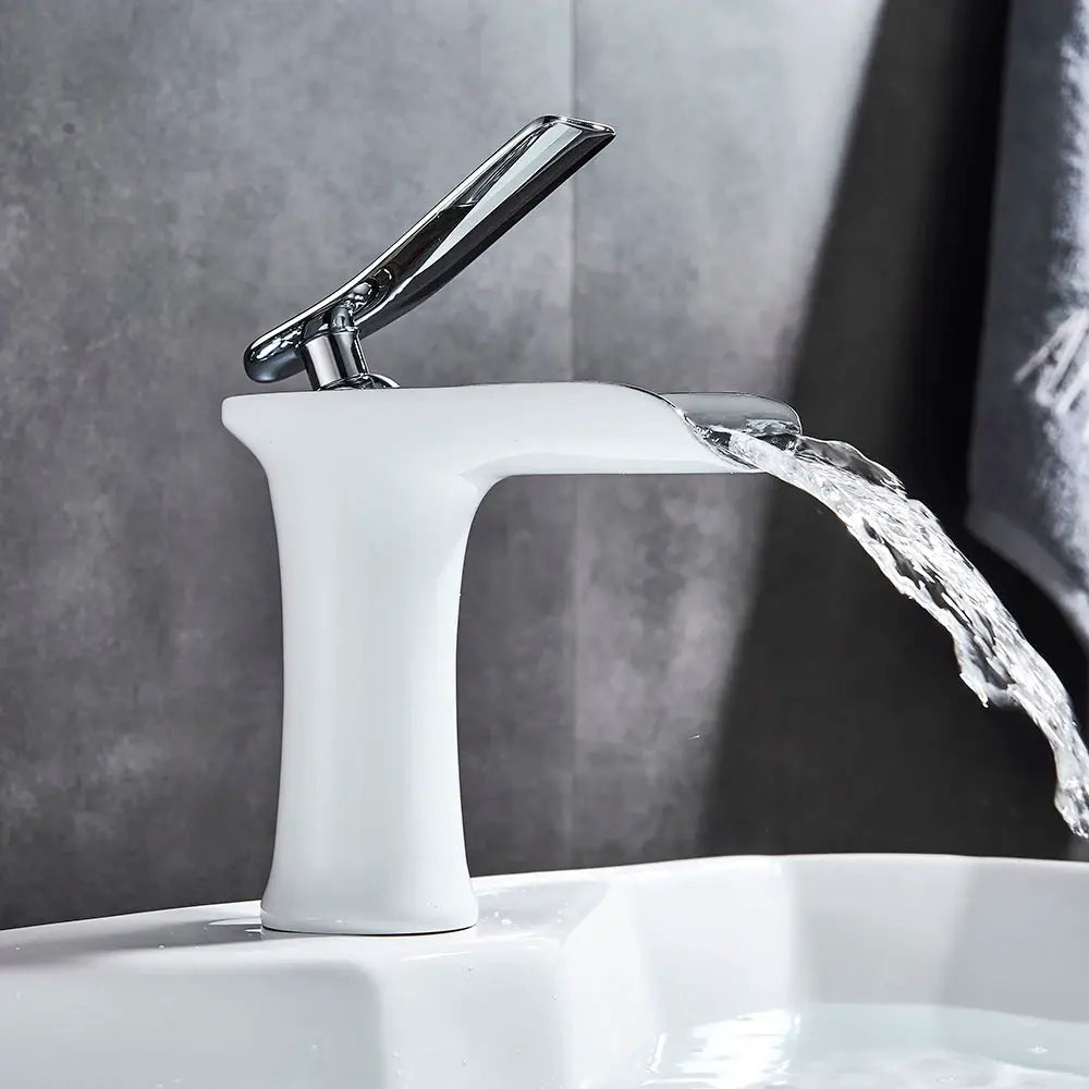 Basin faucet with white ceramic body and chrome single-handle lever, water flowing from the spout.