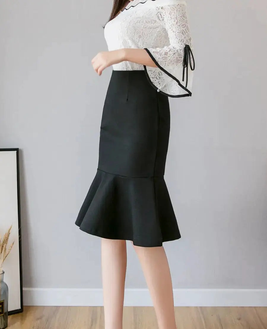Black high-waisted mermaid midi skirt with a ruffled flared hem.