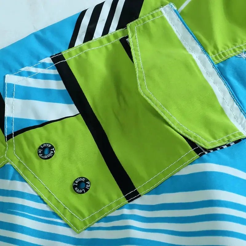 Men's lime green board shorts with front pocket and white stitching