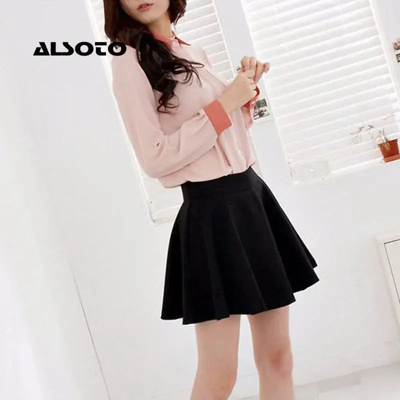 ALSOTO women's black pleated mini skirt with elastic waistband, styled with a pink blouse in a bright room by a window.