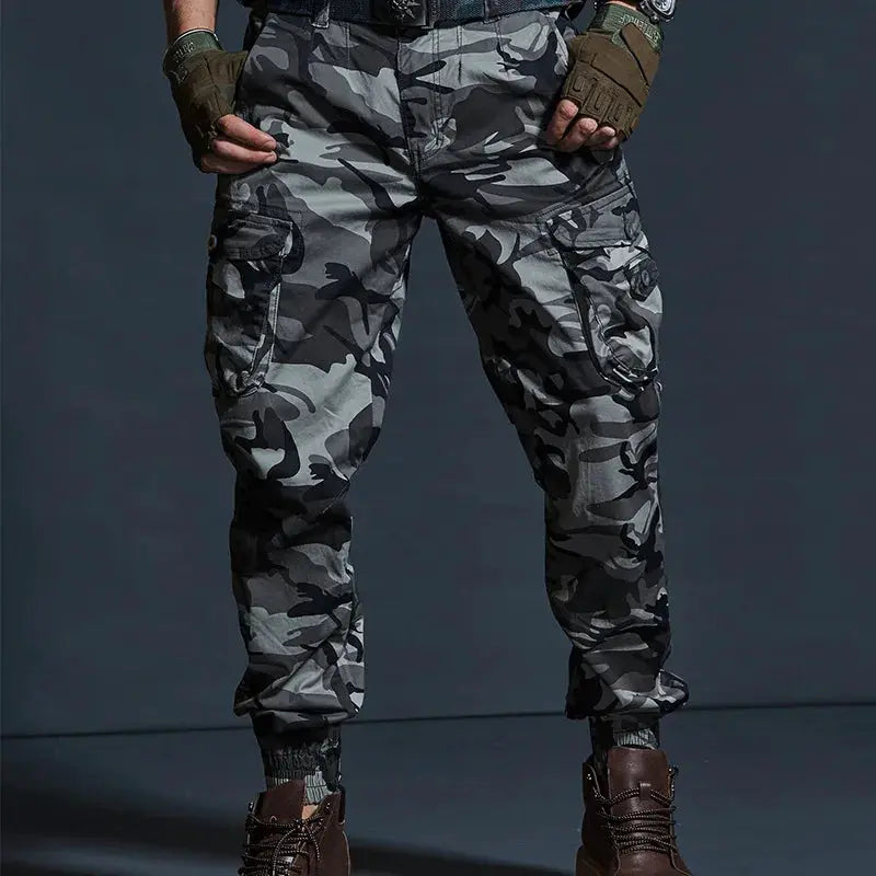 Men's camouflage cargo jogger pants with multiple pockets in gray-black camo.
