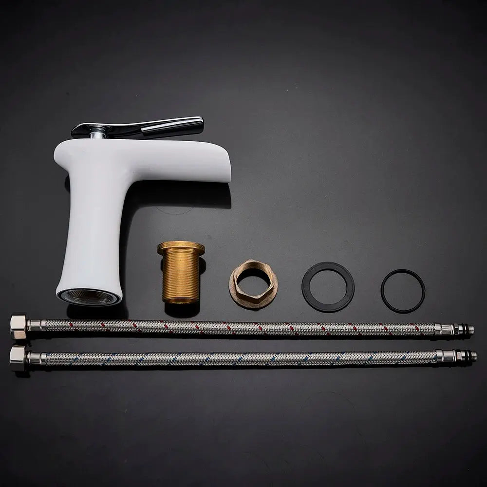 Simples Market basin faucet set with white waterfall-style single-handle faucet, brass fittings, and braided hoses.