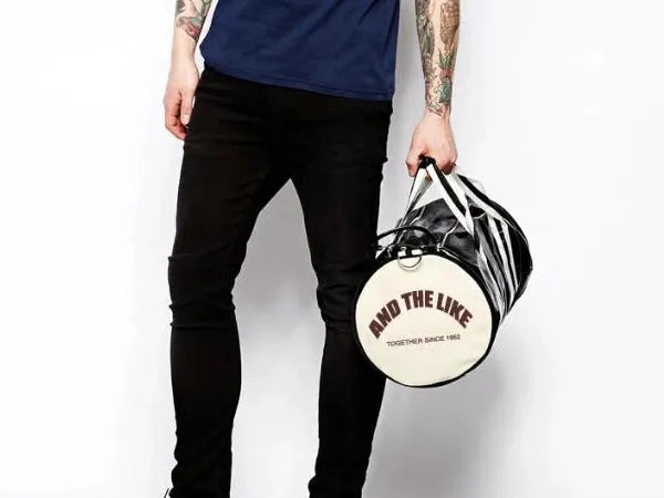 Sport gym bag with black-and-white striped panels and beige circular end cap