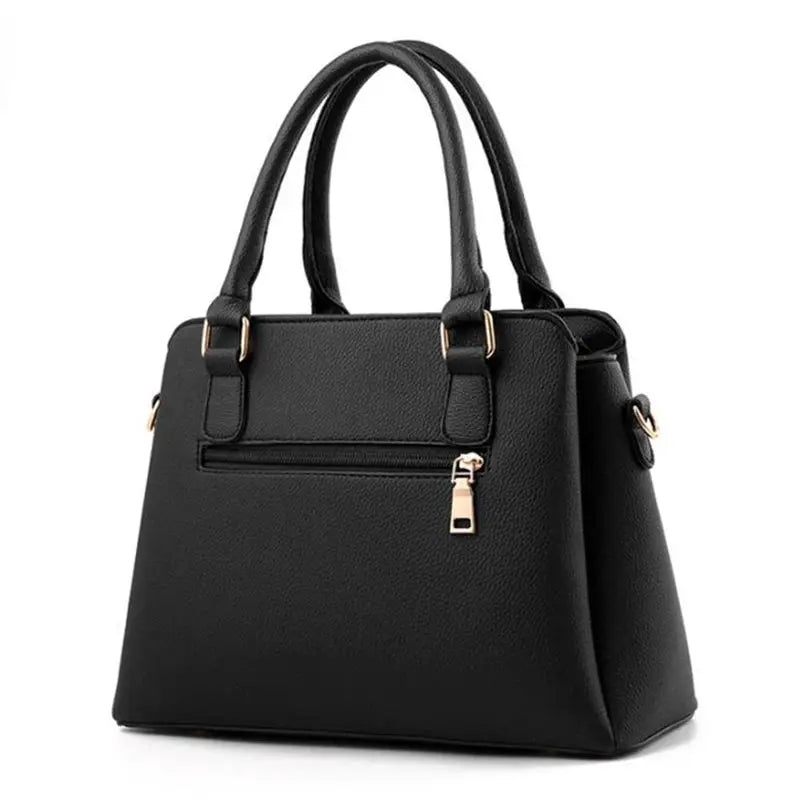 Black PU leather tote bag with top handles and gold-tone hardware, back zipper pocket